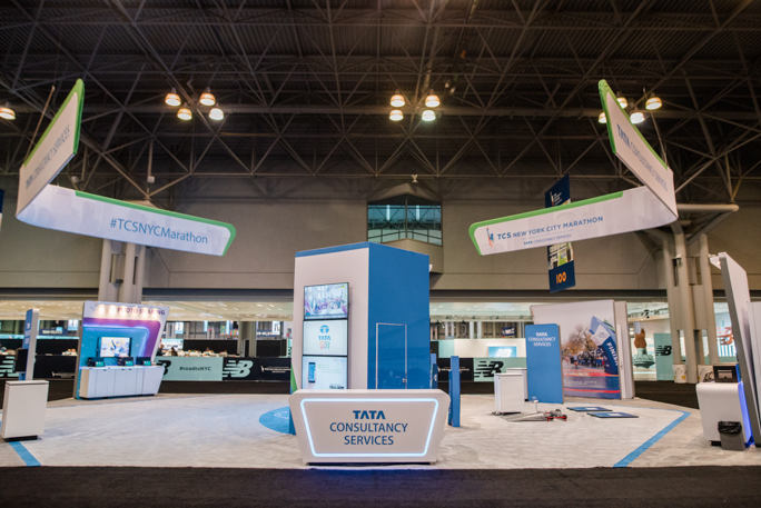 blue expo booth with three screens