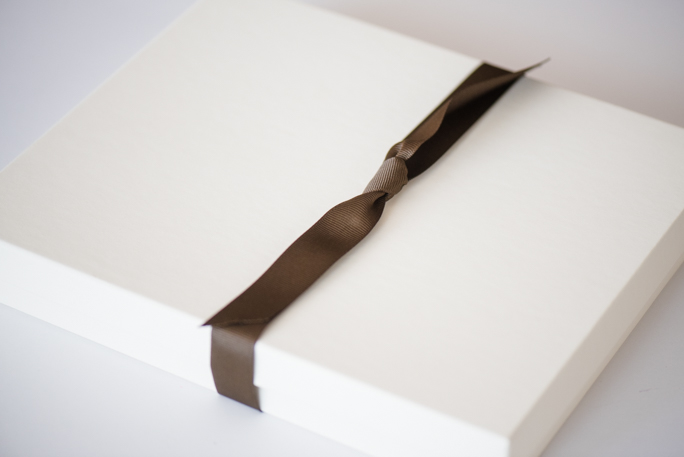 A white box with brown ribbon 