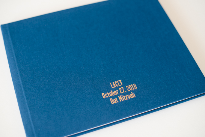 A navy photo album with gold foil printing 