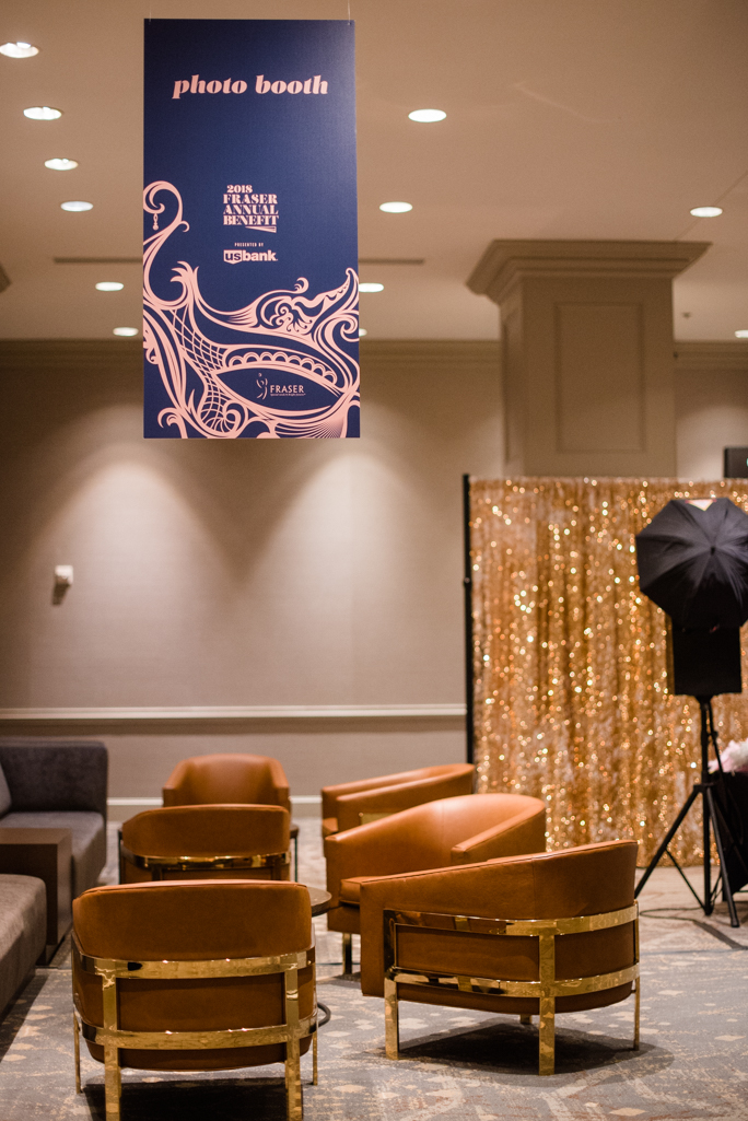 Gold backdrop and a photo stand next to furniture