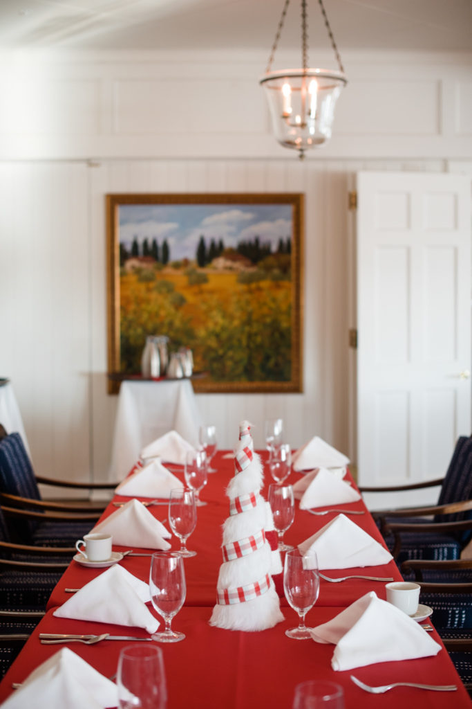 room with a red table and a painting 