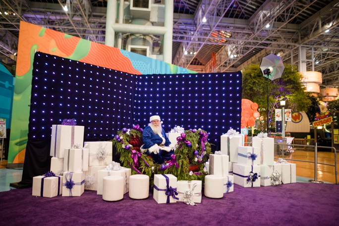 Santa surrounded by white gift boxes