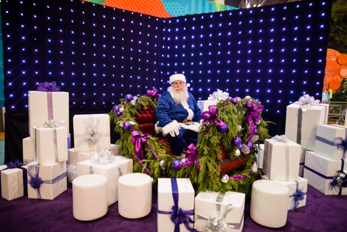 Santa surrounded by white gift boxes
