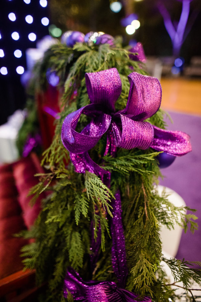 Christmas tree branch with a purple ribbon 