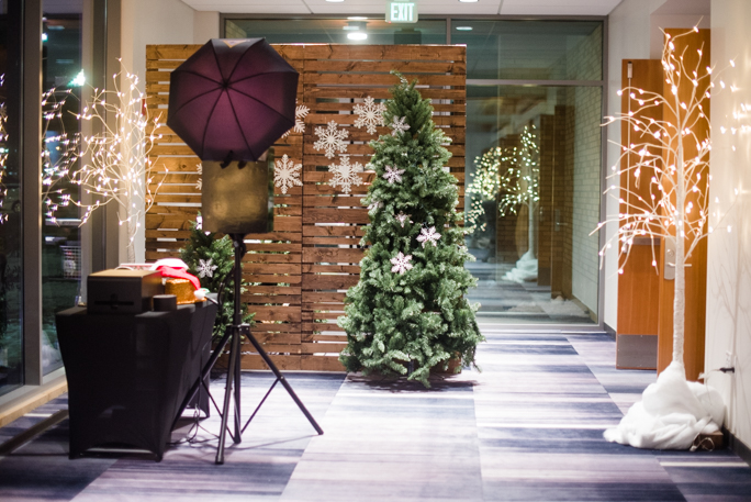 Christmas tree next to a wooden backdrop 