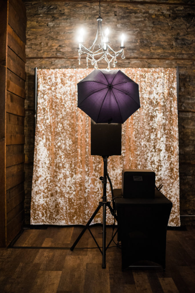 Open Style Photo Booth next to a backdrop 