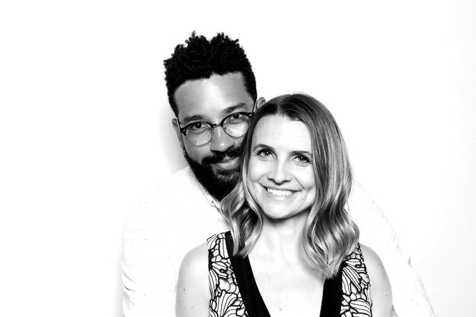 A couple smiling for a black and white photo