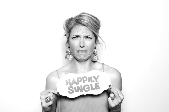 Black and white photo of a woman with a sign