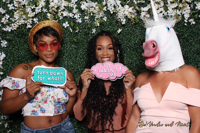 Women posing for a photo with signs