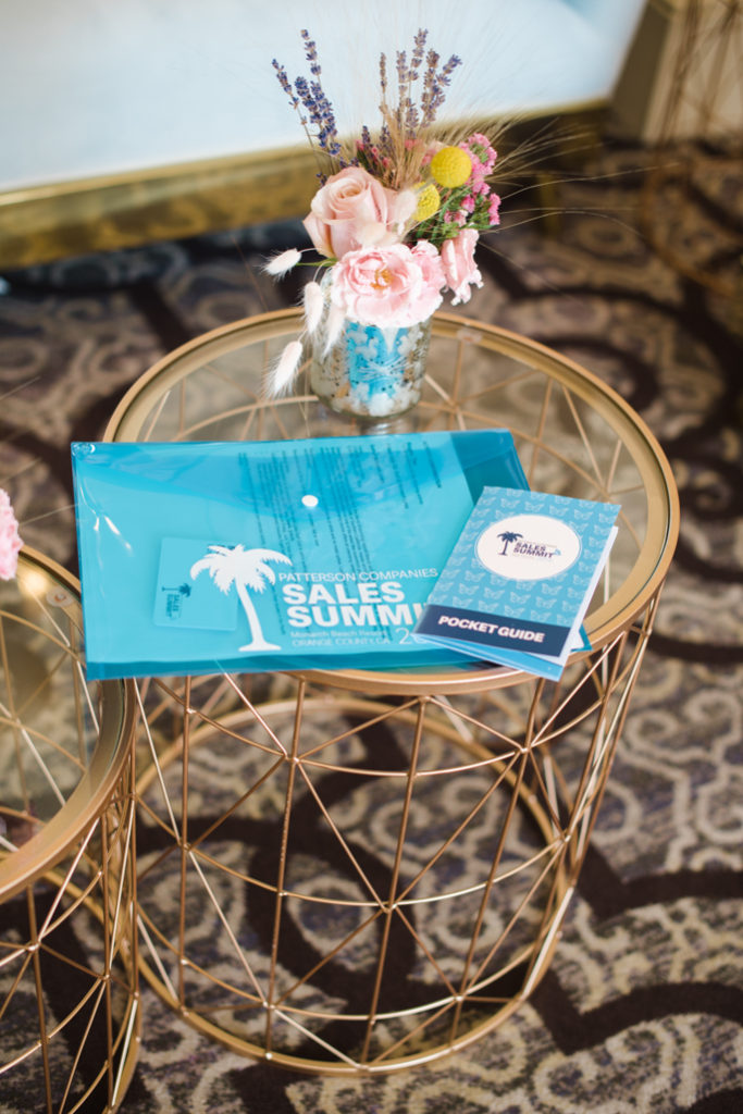 A table with flowers and blue folders