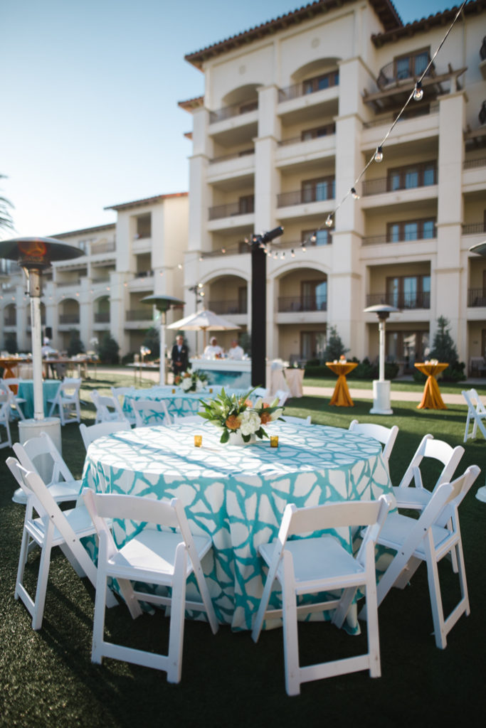 A table with chairs with flowers on top 