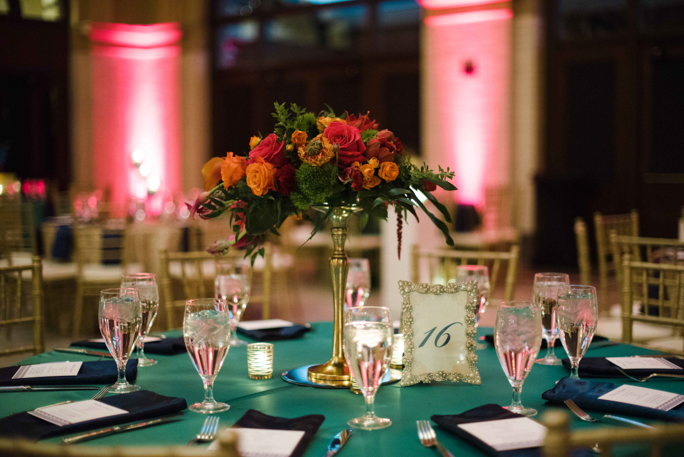 A decorated table with flowers and glasses 