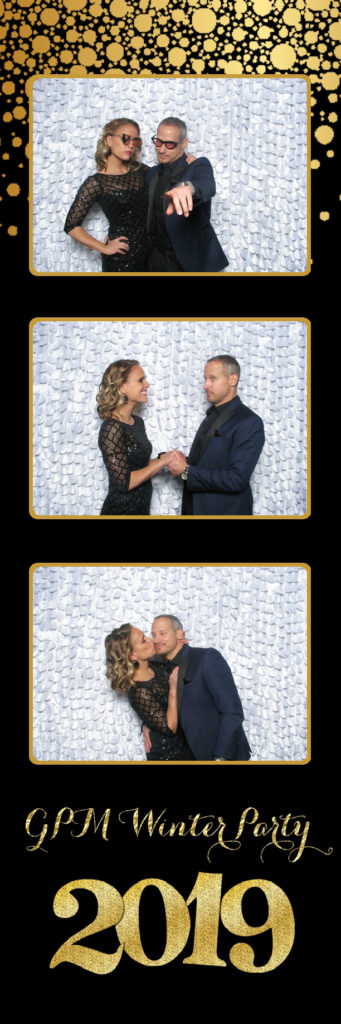 A couple posing for phoots against a white backdrop