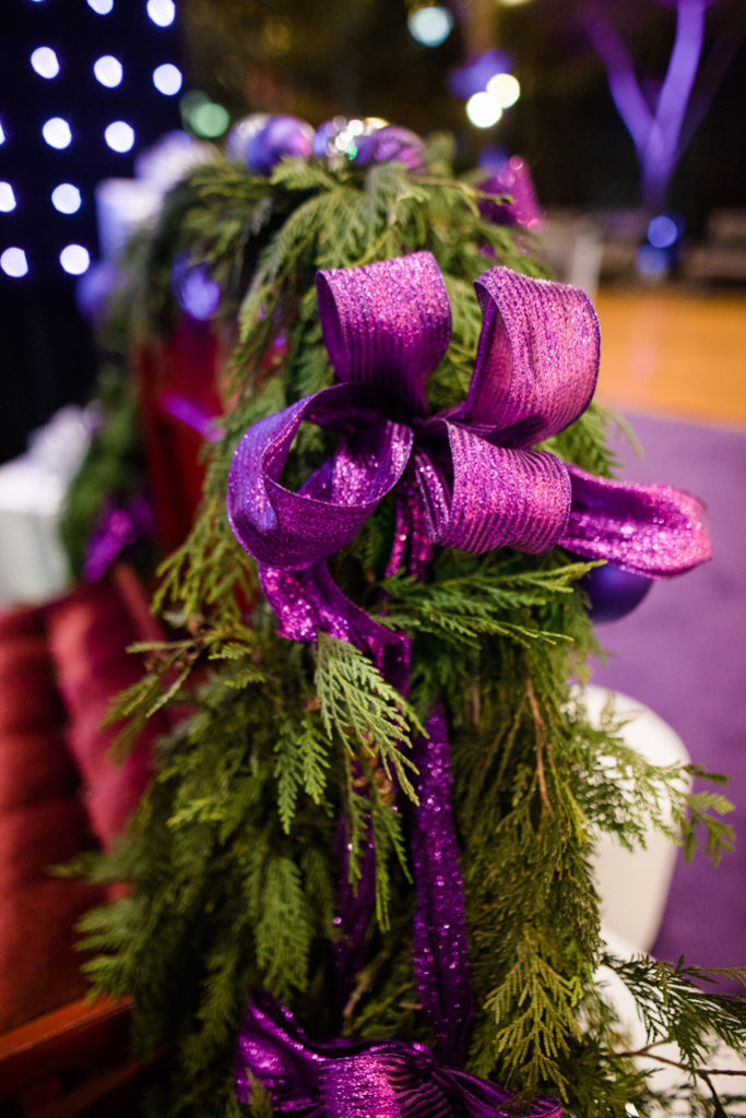 Christmas tree branch with a purple ribbon