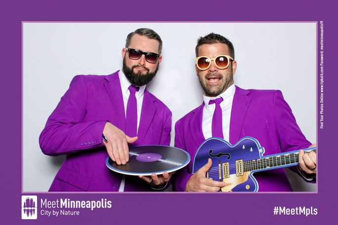 Two men wearing purple and sunglasses