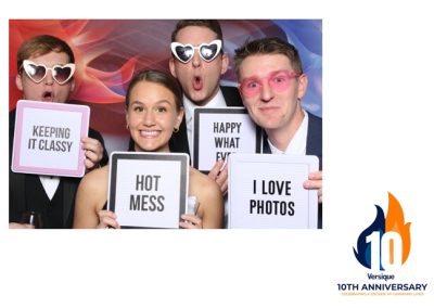 People with signs in a photo booth