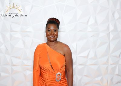 A smiling women on a red carpet