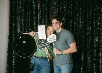 A couple smiling with props