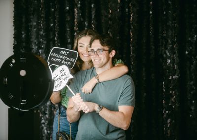 A couple smiling with props