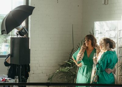 Women taking photos in the open booth