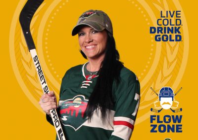 A smiling woman with a hockey stick