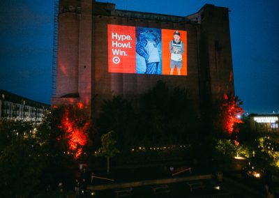 Photo booth slideshow projected on silo wall at Surely Brewery corporate event in Minneapolis