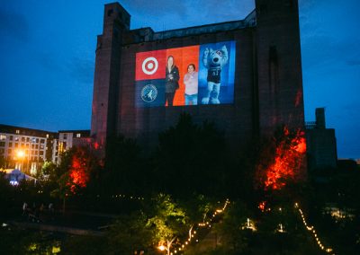 Photo booth slideshow projected on silo wall at Surely Brewery corporate event in Minneapolis