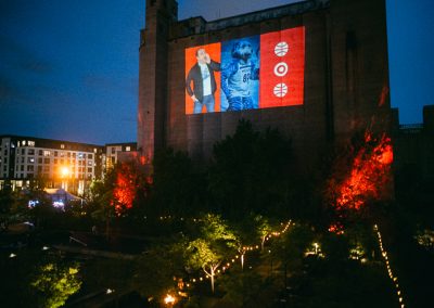 Photo booth slideshow projected on silo wall at Surely Brewery corporate event in Minneapolis