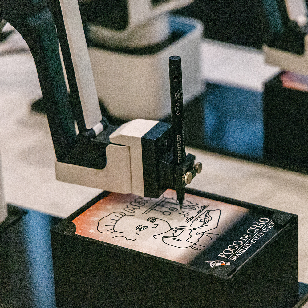 Drawbot robotic arm drawing a portrait