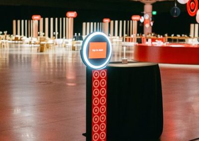 Branded open style photo booth kiosk with custom tap to start screen at a corporate brand activation