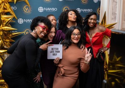 Group of guests posing together in an open style photo booth at a corporate event in Minneapolis