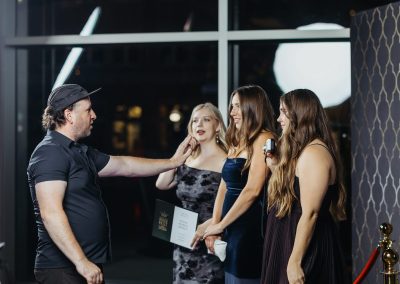 Glam Bot attendant directing a group of guests on the red carpet before their slow motion video
