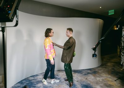 Two guests in bold outfits filming a Glam Bot video at a Minneapolis brand activation
