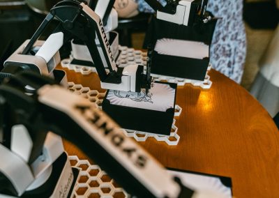 Sketch Bot rental in Minneapolis - robot arms drawing guest portraits in pen at an event