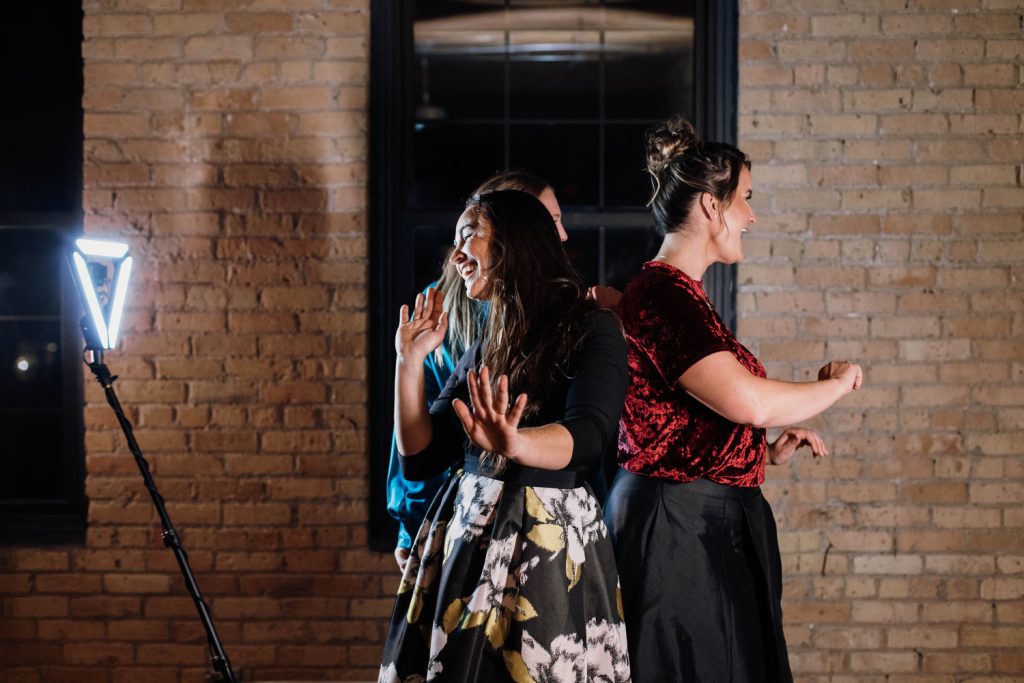 Guests dancing in front of a 360 photo booth at a Minneapolis wedding reception