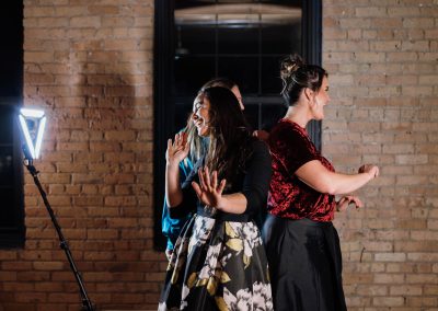 Guests dancing and posing at a 360 photo booth during a Minneapolis wedding reception