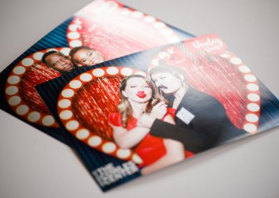 Branded corporate photo booth prints with a custom logo overlay from an event activation