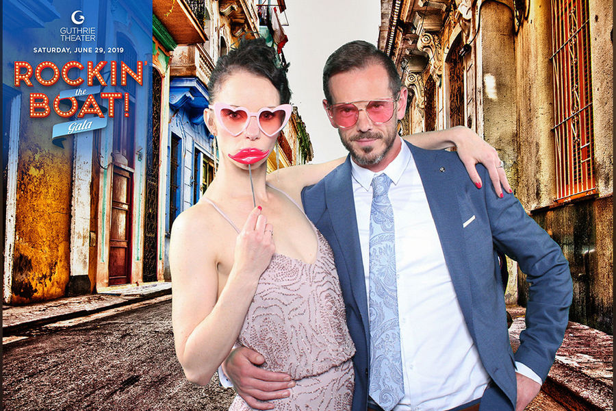 Green screen photo booth print of a couple on a colorful city street