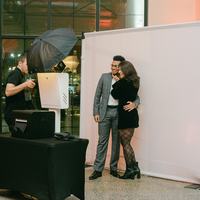 Photo booth attendant running an open style booth