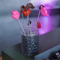 Photo booth props including lips and mustaches on sticks in a jar