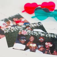 Stack of unlimited photo booth prints on a table