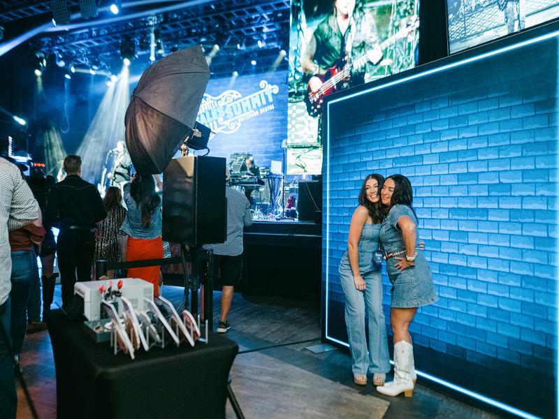 Open style photo booth setup at a Minneapolis event venue with brick wall