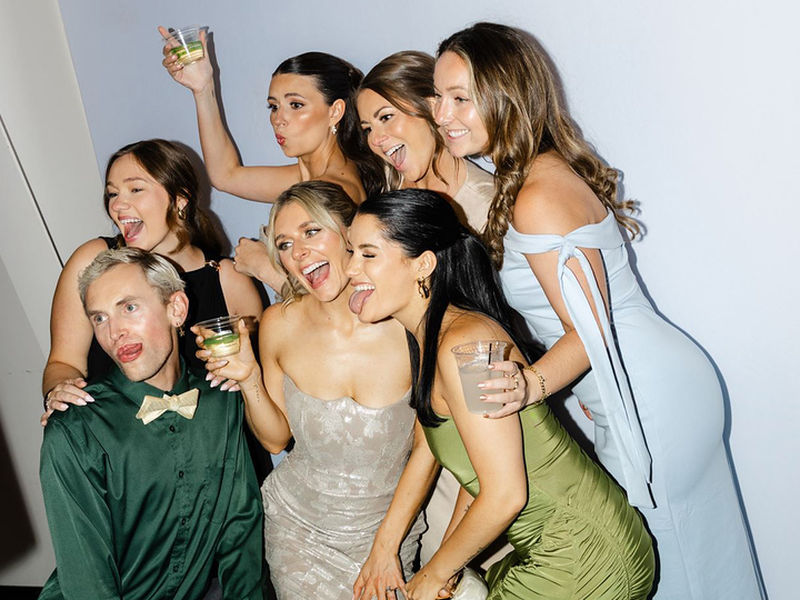 Bridesmaids posing together at an open style photo booth