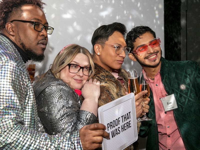 Guests posing with props at an open style photo booth corporate event in Minneapolis