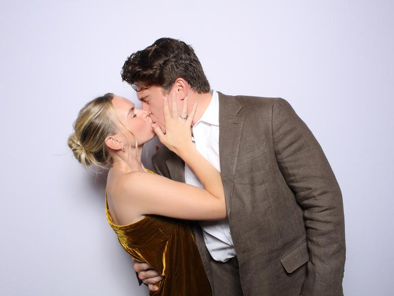 Couple kissing in an open style photo booth portrait