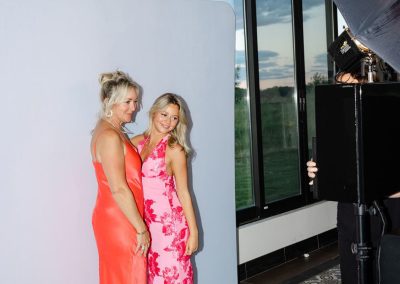 Mother and daughter posing at an open style photo booth at a Minnesota event