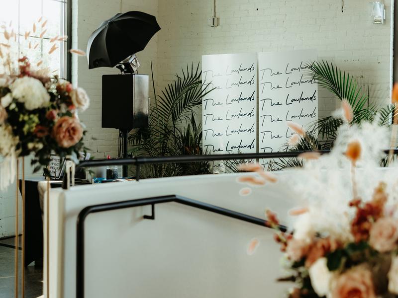 Open style photo booth setup with floral decor at a Minneapolis venue