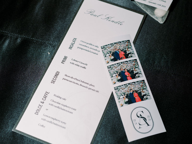 Wedding reception menu with an open style photo booth strip at the place setting