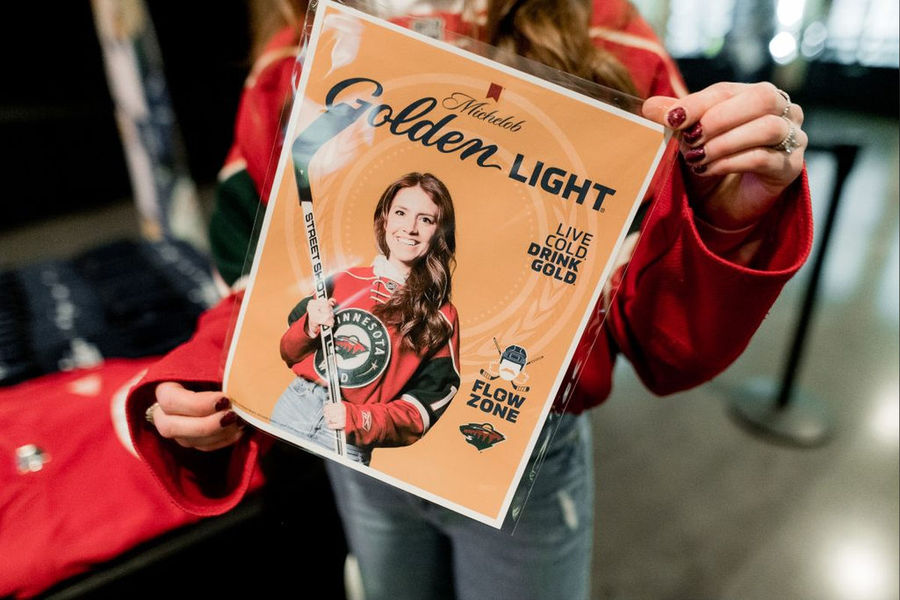 Guest holding a custom poster print from a photo booth activation