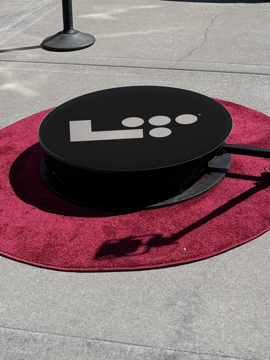 360 photo booth platform printed with a custom wrap: black and white brand logo